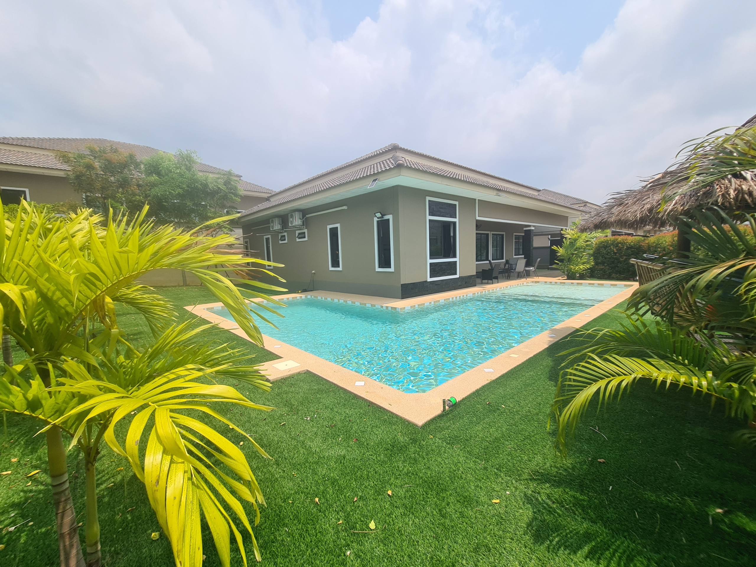 Luxury 5-bedroom pool villa in Bang Saray, Thailand, featuring a private pool, landscaped garden, and modern interiors.