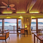 Luxury beachfront penthouse in Koh Chang with freehold ownership, stunning sea views, spacious living area, modern Thai design, high ceilings, private pier, and fully furnished with a large kitchen. Listed with Koh Chang Properties.