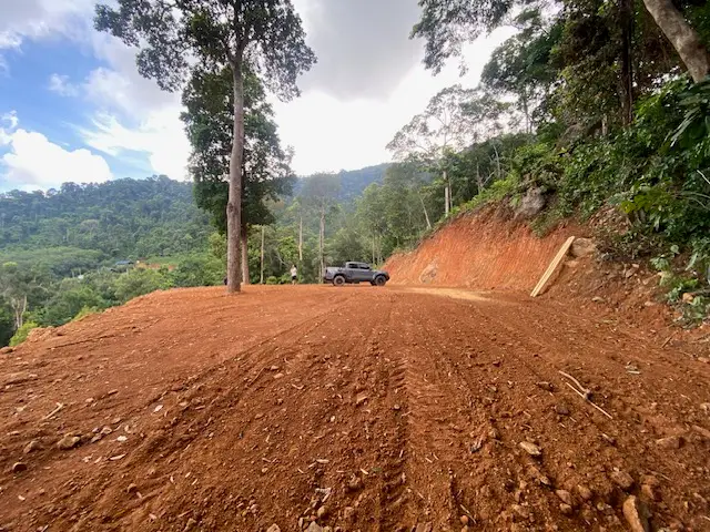 Panoramic sea view land for sale on Koh Chang with mountain elevation, surrounded by lush nature and ideal for luxury villa or resort development.