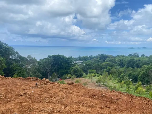 Panoramic sea view land for sale on Koh Chang with mountain elevation, surrounded by lush nature and ideal for luxury villa or resort development.